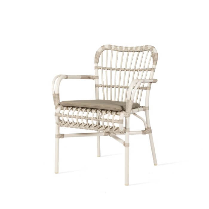 Indulge in the sophistication of outdoor dining with this elegant white Aluminium and weave armchair, featuring a plush taupe seat pad for added comfort.