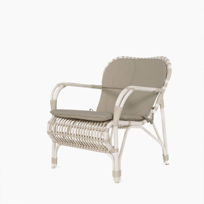 A stylish white wicker outdoor lounge chair with a comfortable taupe cushion, perfect for relaxation and leisure.